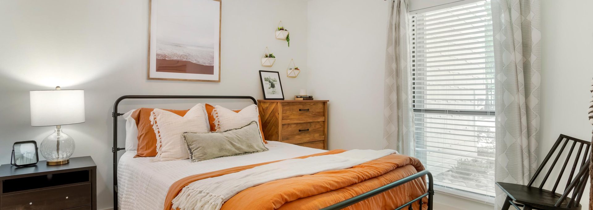 a bedroom with a bed, dresser and fan at The  Marley